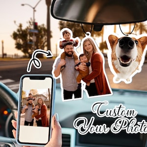 May include: A set of three car air fresheners with custom photos. The air fresheners are hanging from the rearview mirror of a car. The photos show a family of four, including a dog. The text "Custom Your Photos" is visible in the image.
