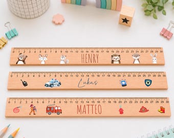 May include: Three wooden rulers, each 30 centimeters long, featuring printed designs. The top ruler displays woodland animals and the name Henry. The middle ruler shows police-themed icons and the name Lukas. The bottom ruler features firefighter-themed graphics and the name Matteo.
