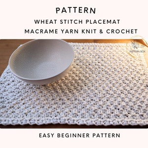 May include: A white crocheted placemat with a wheat stitch pattern. The placemat is made with macrame yarn and is an easy beginner crochet pattern.