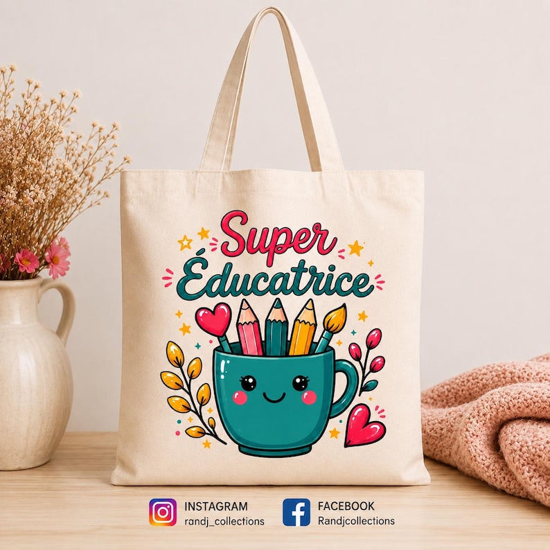 May include: A cream-colored canvas tote bag featuring a colorful graphic of a smiling teal mug filled with pencils and a paintbrush. The text reads Super &Eacute;ducatrice in pink and teal script. Decorative elements include yellow stars, pink hearts, and leafy branches.