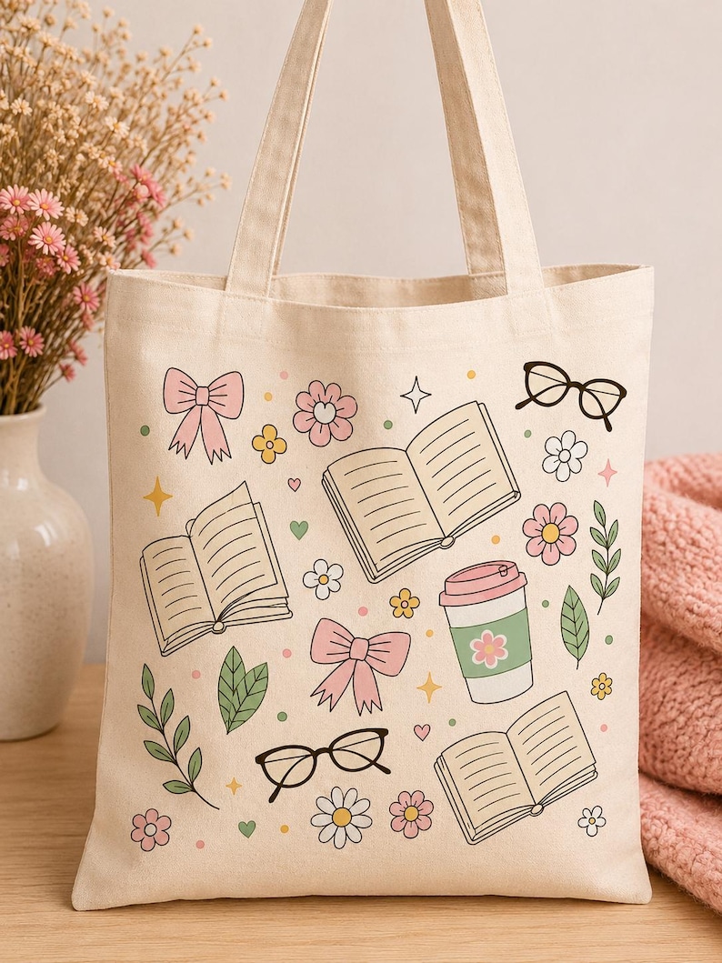 May include: A cream-colored canvas tote bag featuring a repeating graphic print of open books, pink bows, black-rimmed glasses, a coffee cup with a green sleeve, and various small flowers, leaves, hearts, and stars in shades of pink, green, and yellow.