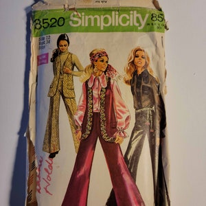 May include: Vintage Simplicity sewing pattern number 8520 for a women's pantsuit. The pattern includes three different styles of pants and a vest. The pattern is printed on a white background with a green Simplicity logo. The pattern is for sizes 12 and bust 34.