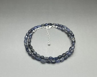 May include: A double-strand necklace made of blue gemstone beads with a silver clasp.