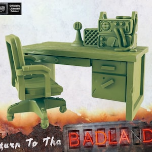 May include: A green plastic desk with a drawer and a green plastic chair. There is a green plastic radio on the desk. The desk and chair are part of a miniature set for tabletop role-playing games.