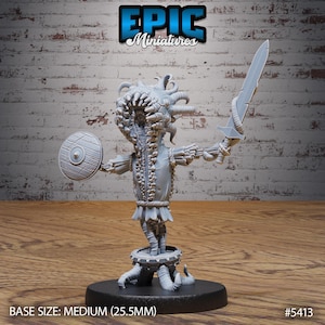 May include: A gray miniature figure of a creature with a large, toothy mouth, holding a sword and shield. The figure is on a round base, with the text "EPIC Miniatures" at the top. The base size is medium (25.5mm).