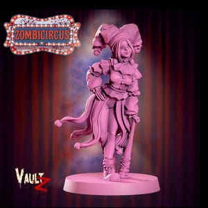 May include: A pink figurine of a female jester with a large hat, ruffled collar, and long, flowing tails. The figurine is holding a staff and stands on a circular base. The image includes the text "ZOMBICIRCUS" and "Vault Z".