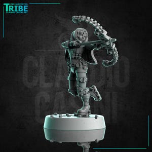 May include: A detailed 3D-printed figurine of a character in a dynamic pose, holding a futuristic bow and arrow. The figure is clad in armor and a hooded cloak, standing on a circular base. The image includes the text "TRIBE" and "CLAUDIO CASINI ART".