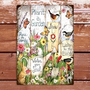 May include: A metal sign with a garden theme. It features a watering can, flowers, butterflies, birds, and the text "Plant a Garden, Grow Love, Share the Bounty, Water your Soul, Listen to the Birds".