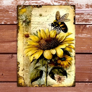 May include: A vintage-style metal sign featuring a yellow sunflower with a bee perched on a petal. The background is a faded, cream-colored paper with handwritten text.