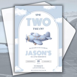 May include: A light blue birthday invitation with a vintage airplane illustration. The invitation reads "Time Two Take Off" and includes details for Jason's second birthday, with a date and time. The invitation is inside a white envelope.