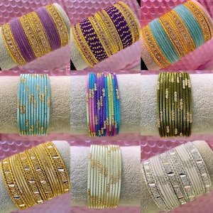 May include: A selection of vibrant bangles in shades of purple, teal, gold, and green. The bangles feature decorative patterns and embellishments, displaying a range of designs and textures. The image showcases a diverse collection of jewellery.