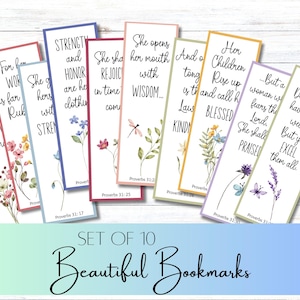 Puede incluir: Juego de 10 hermosos marcadores con detalles florales y citas inspiradoras de Proverbios. Cada marcador presenta un diseño diferente con un borde de color y texto únicos. Los marcadores están dispuestos sobre una superficie de madera blanca.