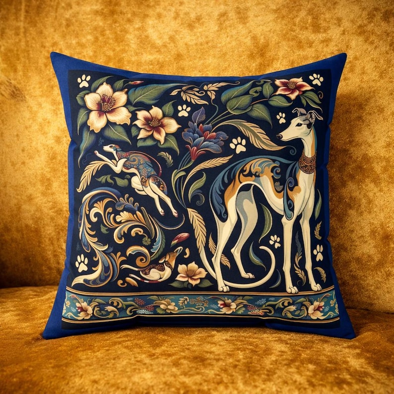May include: A square throw pillow featuring a dark blue background with a repeating pattern of cream and tan greyhound dogs, stylized floral motifs, and small paw prints. The design includes a decorative border with flowers at the bottom edge.