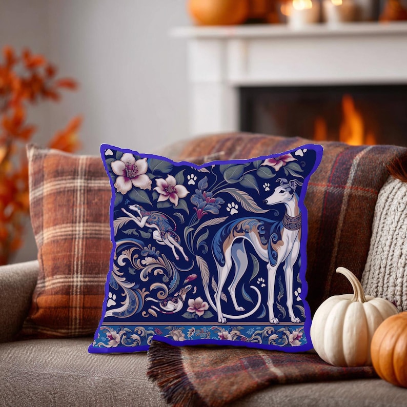 May include: A square throw pillow featuring a dark blue background with a repeating pattern of greyhound dogs, white flowers, swirling acanthus leaves, and small paw prints. The design includes a horizontal border at the bottom with floral motifs.