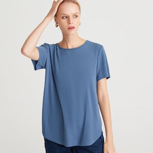 May include: A blue short-sleeved t-shirt with a round neckline. The t-shirt is made of a soft, comfortable fabric and has a relaxed fit.