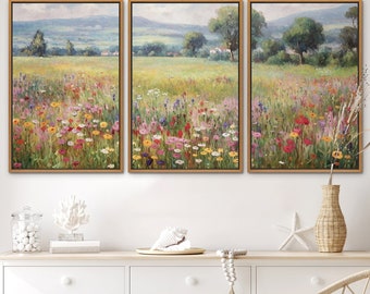 May include: Three framed landscape paintings depicting a field of wildflowers in shades of pink, yellow, white, and red. The paintings are set against a backdrop of rolling hills and a blue sky.