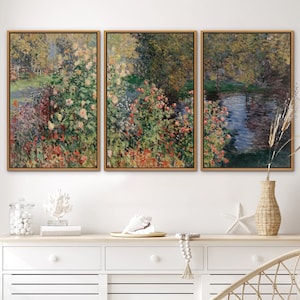 May include: Triptych of framed art prints featuring a garden scene with colorful flowers, trees, and a pond. The artwork has a painterly style with visible brushstrokes and a warm color palette of greens, reds, and yellows. The frames are a light brown color.