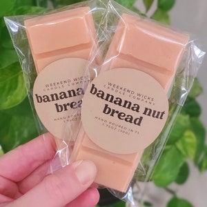 May include: Two wax melts in clear packaging, each with a label that reads "Weekend Wicks Candle Company" and "banana nut bread" with the text "Hand Poured in FL 1.75 oz (50g)".