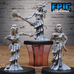 May include: Three gray miniature figurines of a fantasy character. The figurines are of a woman with a seashell staff, a seashell belt, and a long dress. The figurines are on a black base with a pink stand. The text "EPIC Miniatures" is in the upper right corner.