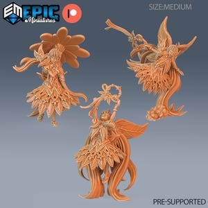 May include: Three orange miniature figurines of fantasy characters. One figure has a large flower behind it, another has a sword, and the third holds a floral wreath. The text "PRE-SUPPORTED" is at the bottom.