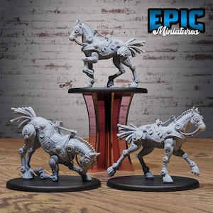 May include: Three gray, mechanical horse figurines with intricate details, gears, and robotic elements. One horse stands on a pedestal, while the other two are on a black surface. The Epic Miniatures logo is visible in the upper right corner.
