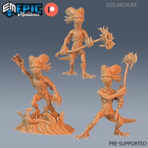 May include: Three 3D printed miniature figures of a humanoid creature with a fish-like head and tail. The figures are posed in different action stances, holding weapons. The figures are pre-supported and ready to be printed.