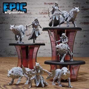 May include: A collection of gray miniature figurines depicting fantasy characters with wolf-like features. The figurines are displayed on tiered platforms with a mirrored finish. Some figures are riding wolves, while others are posed with weapons.