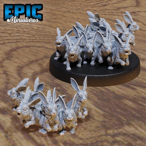 May include: A group of 12 grey rabbit miniatures, some with pointy ears and some with rounded ears, are arranged in a circle on a black base.  The rabbits are all facing forward and have a realistic appearance.  The base is round and has a black finish.  The miniatures are made of a durable plastic material and are perfect for tabletop gaming or display.