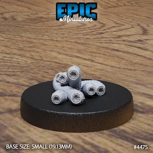 May include: A group of grey, segmented, worm-like creatures with multiple mouths and teeth. The creatures are arranged in a pile on a black circular base. The base is 19.13 mm in diameter. The text "BASE SIZE: SMALL (19.13MM)" and "#4475" are visible in the image.