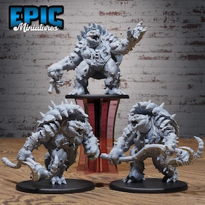 May include: A collection of gray miniature fantasy figures, including a large, spiky turtle-like creature standing on a pedestal and two similar figures on black bases. The figures have detailed armor and menacing expressions. The text "EPIC Miniatures" is in the upper left corner.