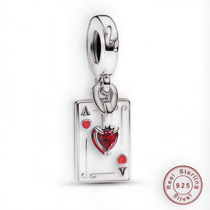 May include: A silver charm featuring a playing card design. The charm depicts the Ace of Hearts, with a red heart symbol and the letter "A". The charm is made of sterling silver and is designed to be a pendant.