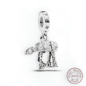 May include: A silver charm depicting an AT-AT walker, a vehicle from a science fiction film. The charm has a loop at the top for attaching to a bracelet or necklace. The charm is made of sterling silver.