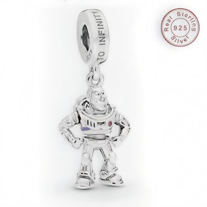 May include: A silver charm featuring Buzz Lightyear from Toy Story. The charm has the words "TO INFINITY" engraved on the top. The charm is made of 925 sterling silver.