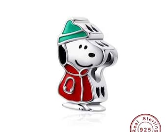 May include: A silver charm featuring a cartoon character in a red coat and green hat. The charm has black accents and a smiling face. The charm is a collectible item.