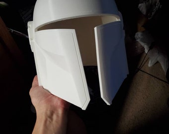 May include: A white plastic helmet with a triangular design on the top and two side panels that can be opened and closed.