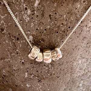 Unique sculptured loops pendant