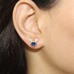Minimalist gold earrings featuring deep blue cubic zirconia and crystal accents. Modern handmade studs by JewelsMinimal for daily use or parties.
 CZ earrings, minimalist jewelry, gold studs, handmade earrings, blue stone