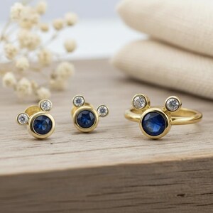 Gold plated stud earrings with blue CZ stone and white crystals by JewelsMinimal. Elegant and minimal earrings perfect for gifting and everyday wear.
 gold plated earrings, blue CZ studs, dainty jewelry, minimal earrings, gift for her