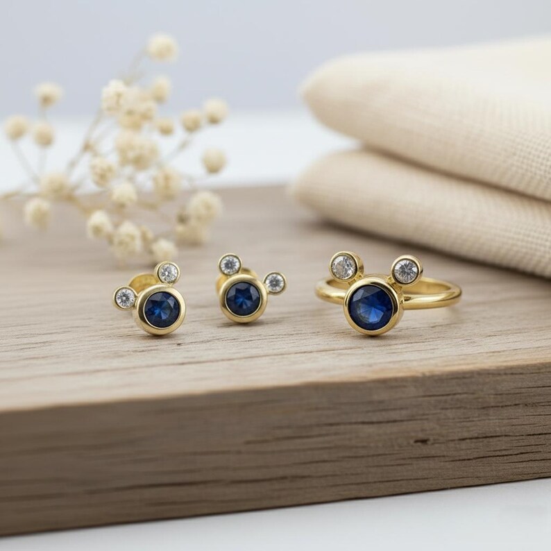 Gold plated stud earrings with blue CZ stone and white crystals by JewelsMinimal. Elegant and minimal earrings perfect for gifting and everyday wear.
 gold plated earrings, blue CZ studs, dainty jewelry, minimal earrings, gift for her
