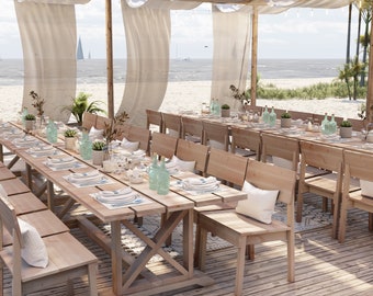 May include: A long wooden table with white linens and light blue glass bottles is set for a beach wedding reception. The table is surrounded by wooden chairs and benches. The ocean is visible in the background.