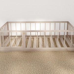 May include: A wooden crib frame with a slatted base and a removable side panel. The crib is made of natural wood and has a simple, classic design.