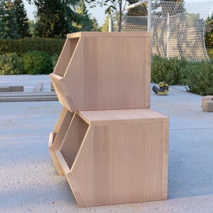 May include: Two unfinished wooden storage bins stacked on top of each other. The bins have a hexagonal shape and are made of light-colored wood.