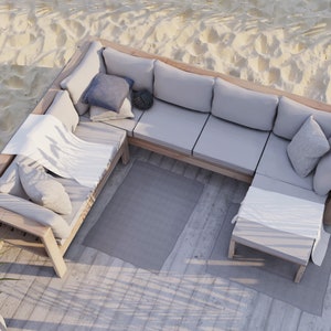 May include: An outdoor sectional sofa with light gray cushions and a wooden frame. The sofa is arranged in an L-shape and includes several throw pillows and a white blanket. A small side table and a gray rug complete the seating area.