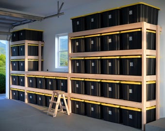 May include: A garage storage system featuring wooden shelving units filled with numerous black storage bins with yellow lids. A small wooden step stool is positioned in front of the shelving.