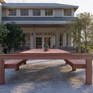May include: A large wooden outdoor dining table with two benches. The table is made of natural wood and has a rustic finish. The benches are also made of wood and have a natural finish.