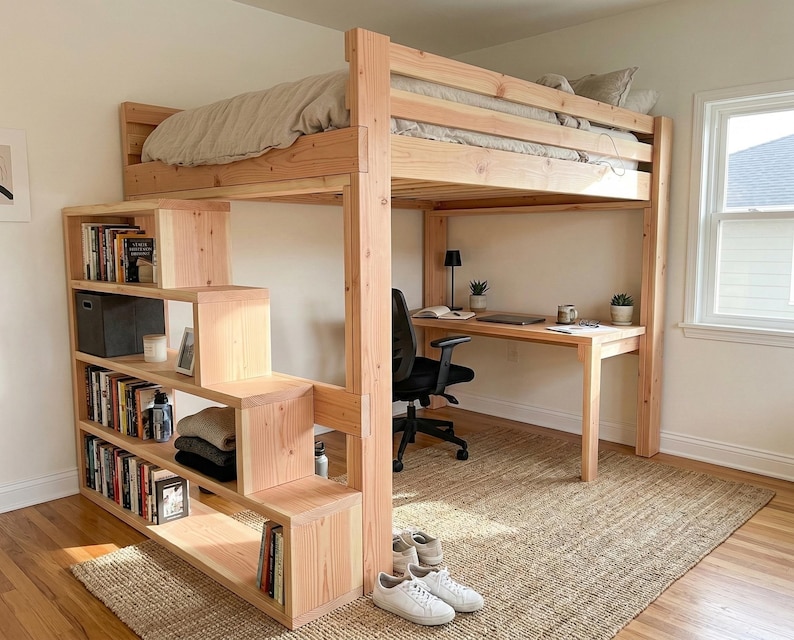 May include: A wooden loft bed with a built-in desk and shelving unit. The bed frame is made of light-colored wood and features a staircase-style shelving unit. The desk is positioned beneath the bed, and the room has a neutral color palette.