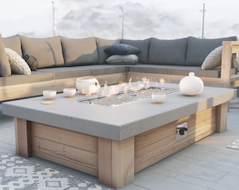 DIY outdoor gas fire pit plan featuring cement slab and propane tank concealing table