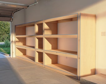 May include: A set of unfinished wooden shelves in a garage. The shelves are made of plywood and have a natural wood finish. The shelves are mounted to the wall and are ready to be painted or stained.