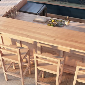 May include: A wooden bar counter with a light wood finish and a natural wood grain. The counter has a built-in shelf and is surrounded by four wooden bar stools. The counter is set up for serving drinks with a bottle of liquor and a tray of lemons and limes.