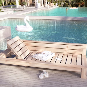 May include: A wooden lounge chair with a white towel and flip flops on the deck next to a swimming pool. A white swan pool float is in the pool.